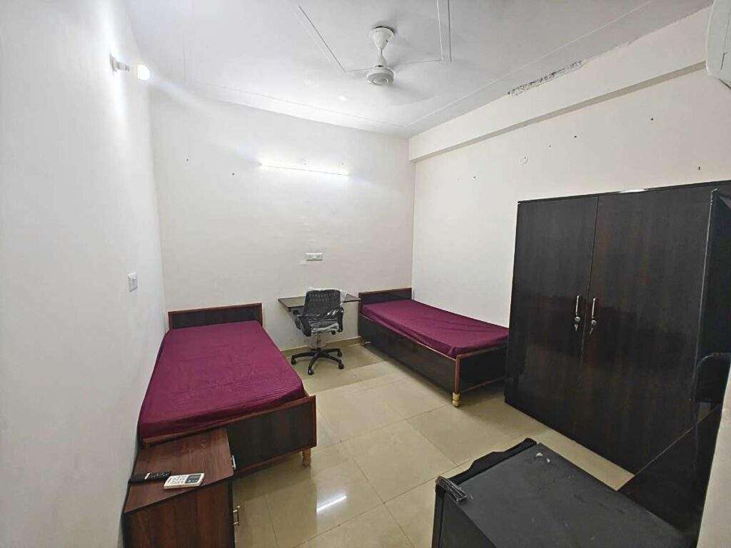 a room with two beds and a desk only for girls pg seventh heaven pg